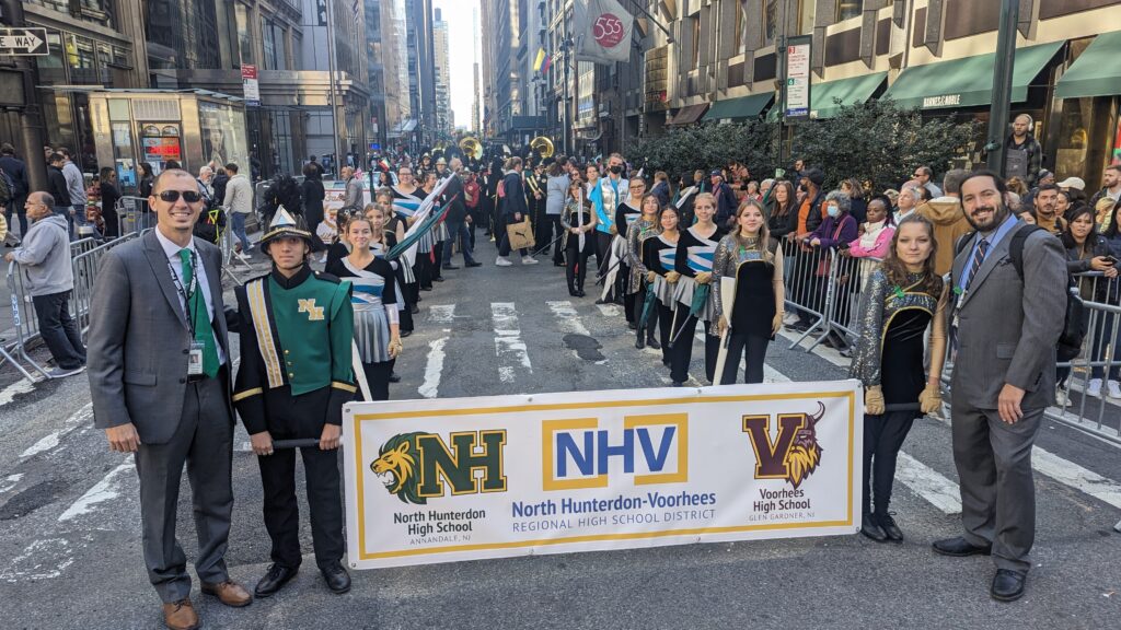 photo of banner with band on parade route