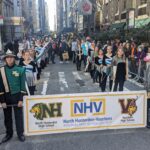 photo of banner with band on parade route