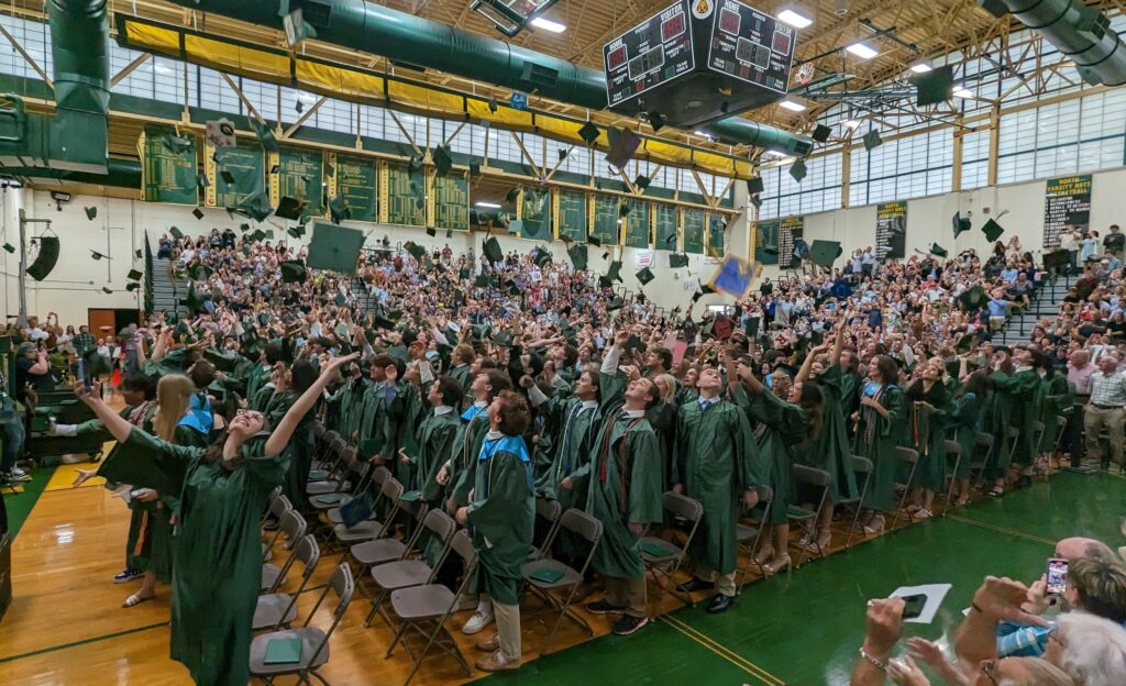 photo of caps flying at NHHS graduation